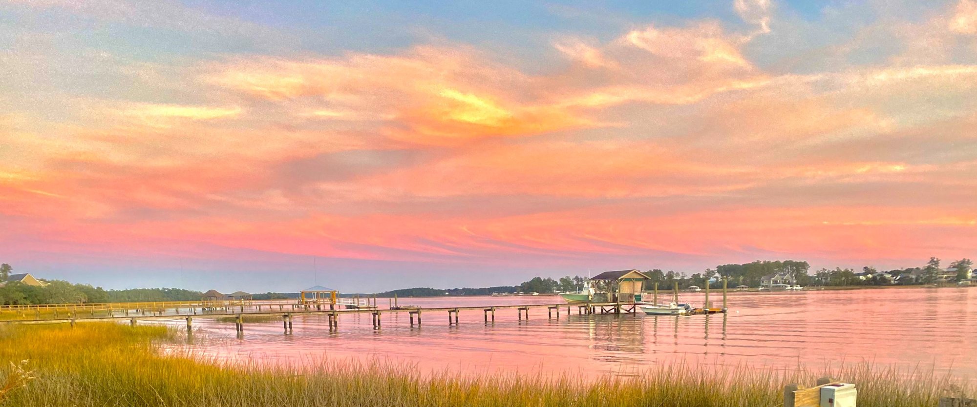 The Wando River at sunset from a pink-lit pier